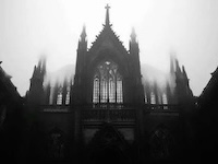 black and white image of dark cathedral exterior