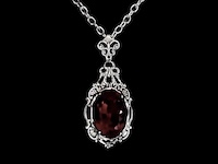 close up of a red gem on a necklace