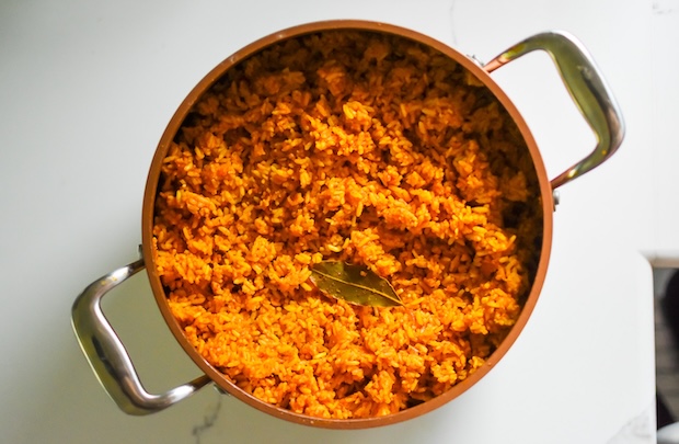 jollof rice in a pot against a white background